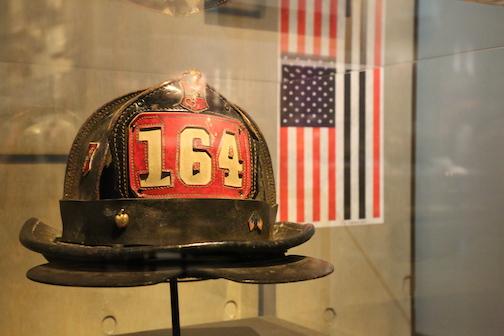 Bob Beckwith’s black and red helmet is on display at the 9/11 Memorial Museum’s historical exhibition. The number 164 is on a patch on the front of the helmet.