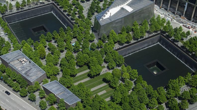 Aerial view of the 9/11 Memorial and Museum on a spring day, with all the oak trees on the plaza in bloom.