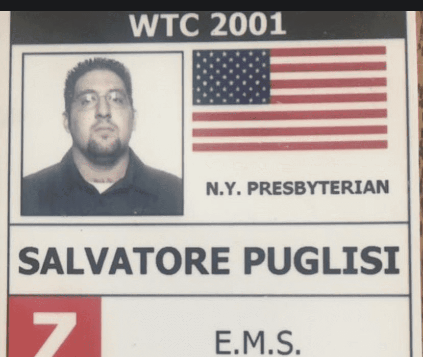 This hospital ID card belonging to Salvatore Puglisi to shows his photo in the upper lefthand corner and the American flag on the right.  His name Salvatore Puglisi and the words EMS are below.